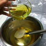 Pouring olive oil into soap oils